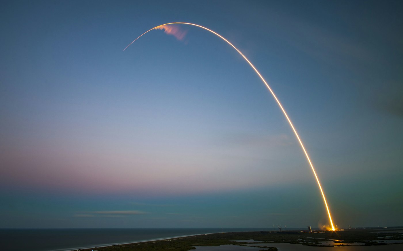 Rocket launch light trail at dusk